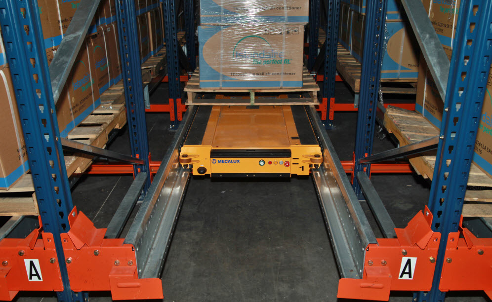 The forklift then positions pallets one by one in the level entrance, resting them on the load-bearing rails